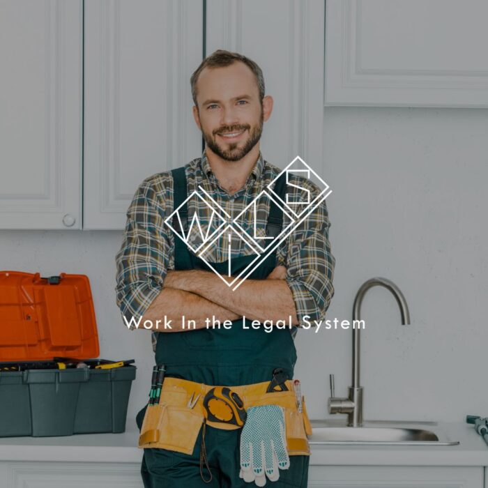Сантехник улыбается на кухне с инструментами на фоне. Логотип Wils